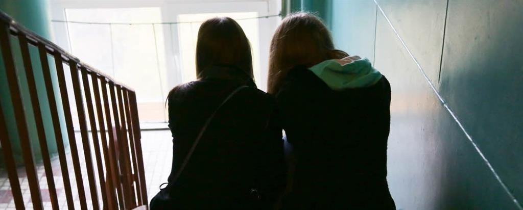 Two women sitting on a staircase